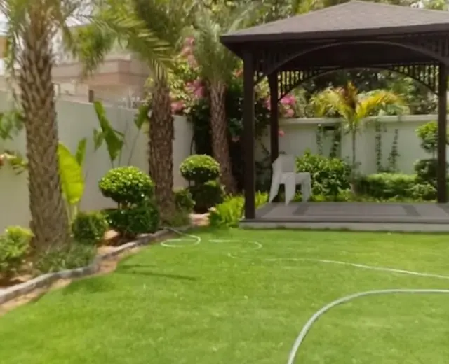Private lawn and tropical garden planting